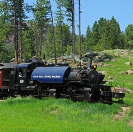 A train with a blue tank that says black hills central railroad