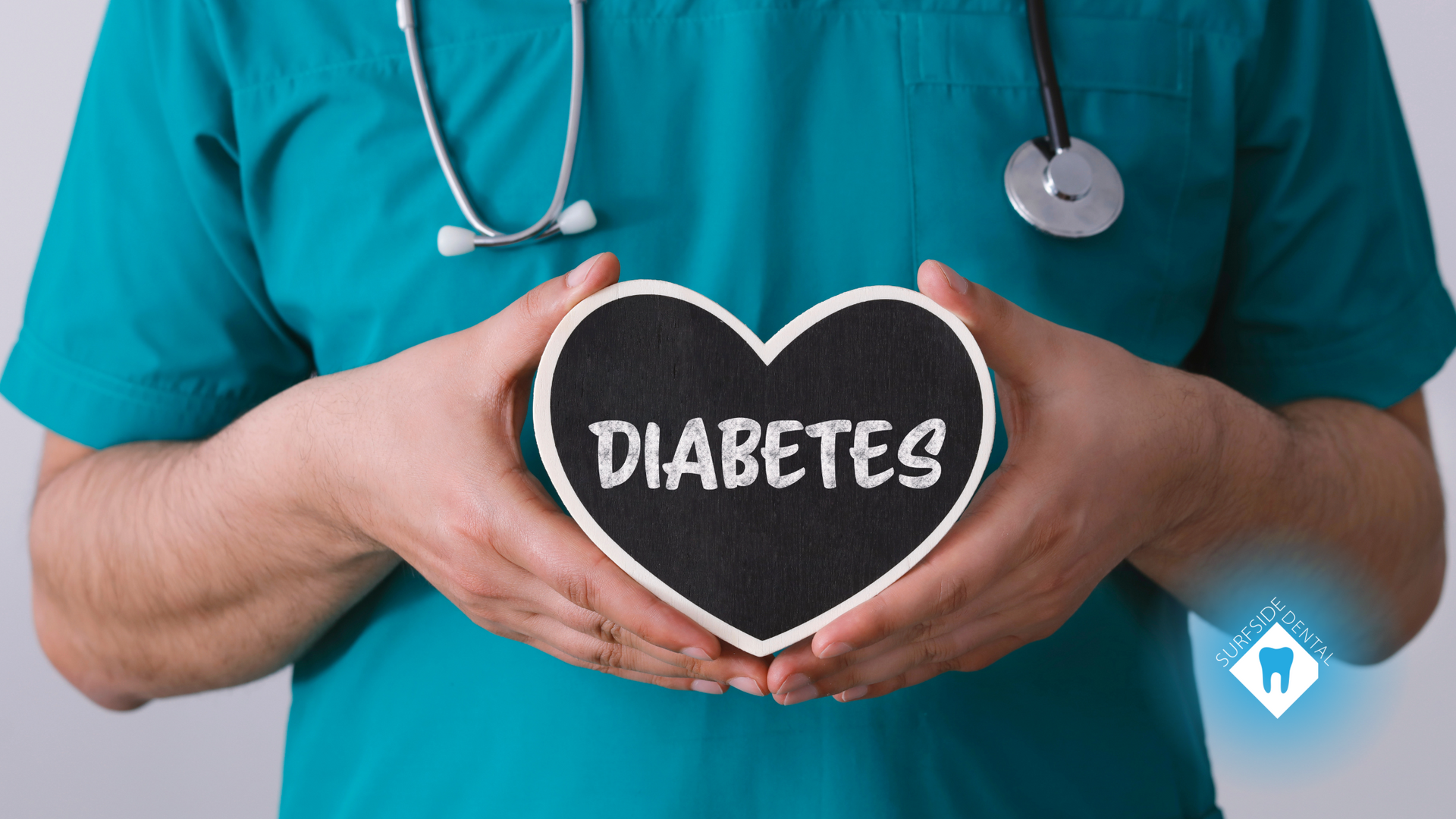 A doctor is holding a heart with the word diabetes written on it.