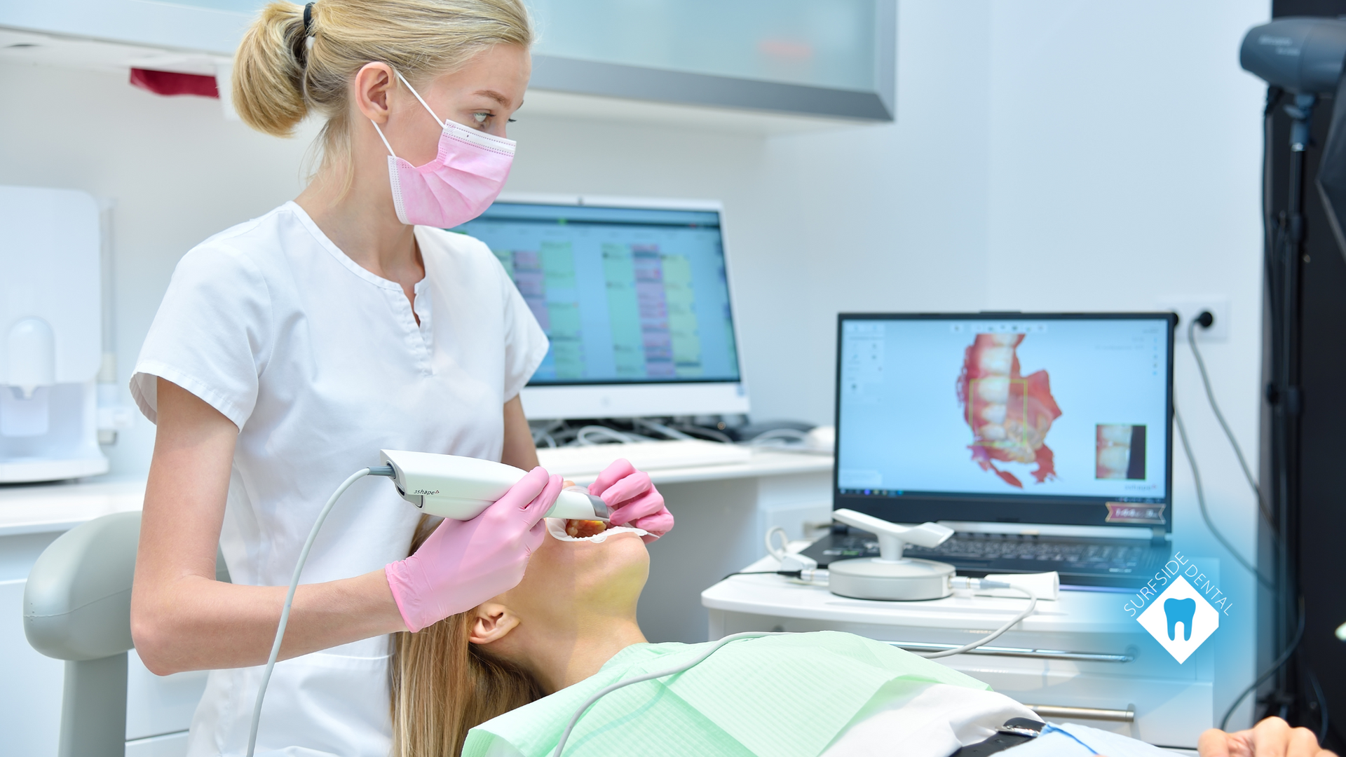A dentist is taking a picture of a patient 's teeth in a dental office.