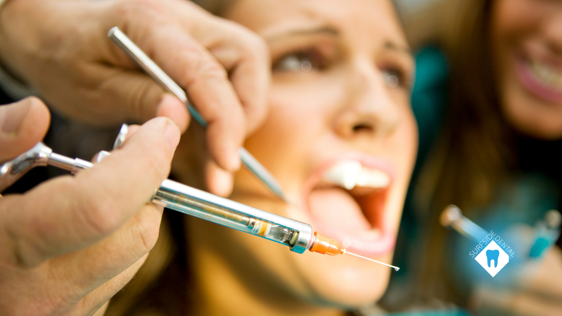 A woman is getting an injection from a dentist.