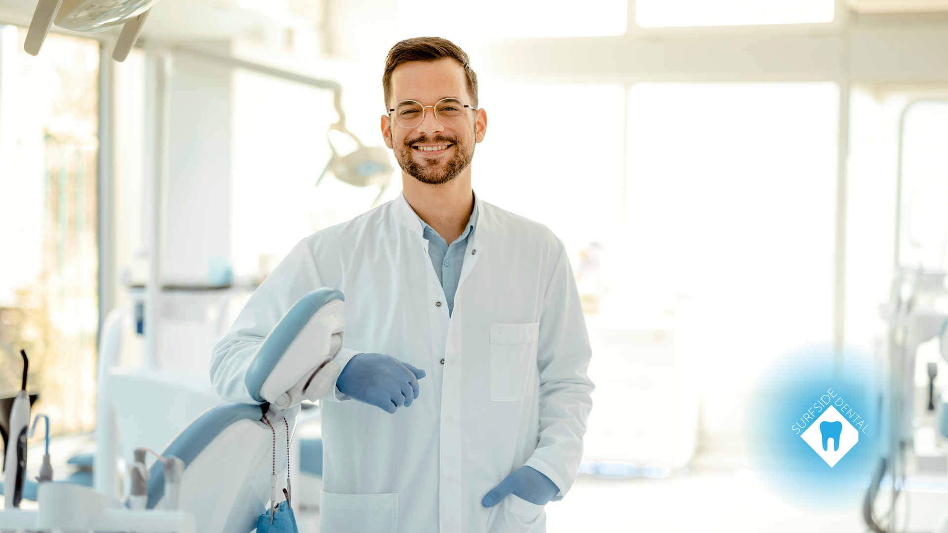A dentist is standing in front of a dental chair in a dental office.