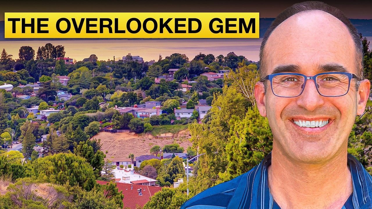Smiling man beside a colorful hillside neighborhood with the title “THE OVERLOOKED GEM”