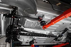 a close up of the underside of a car in a garage