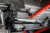 a close up of the underside of a car with red braces