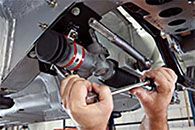 a person is working on a car with a wrench