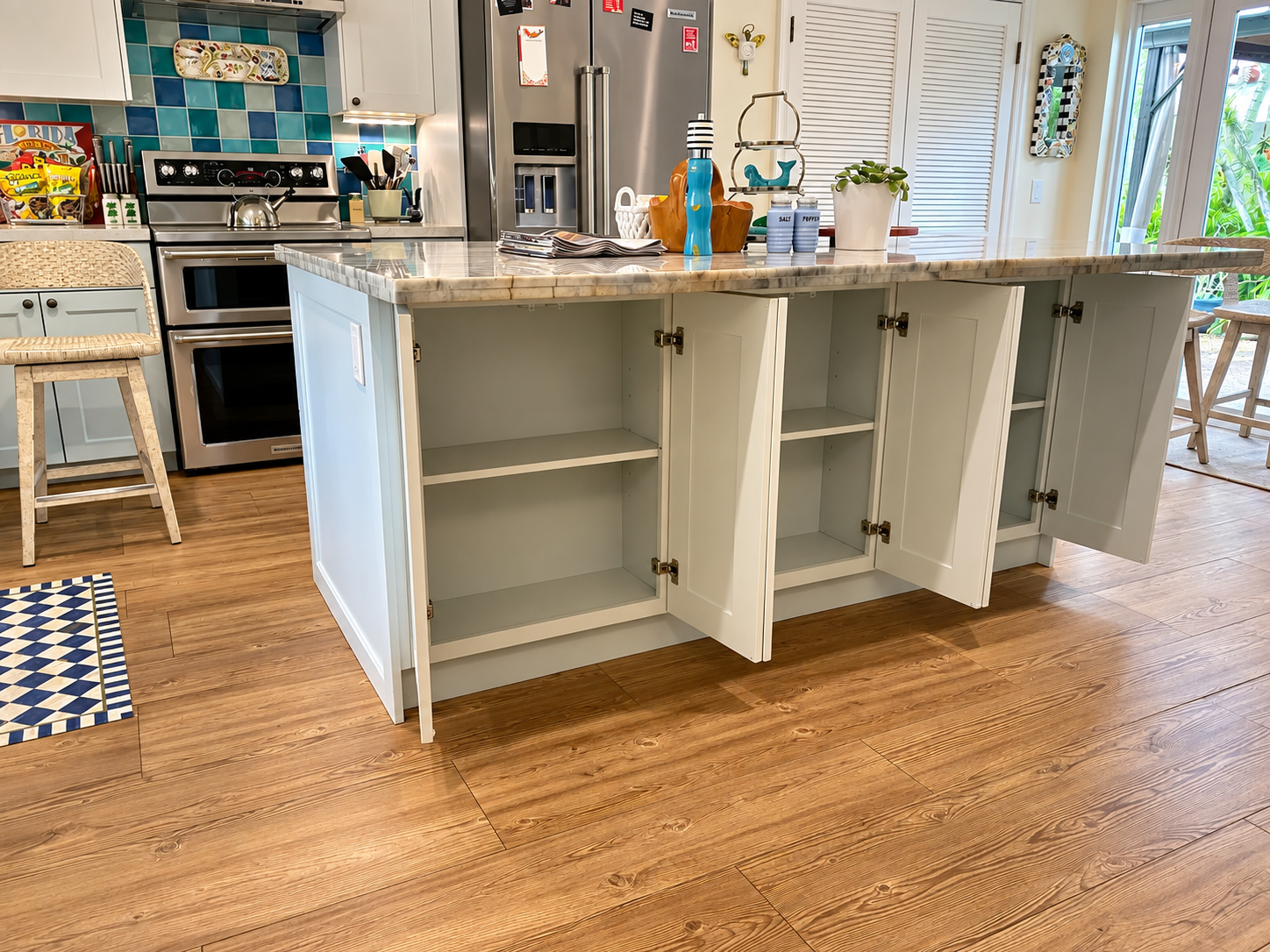 Kitchen island with open cabinets and wooden floor in a bright, modern kitchen