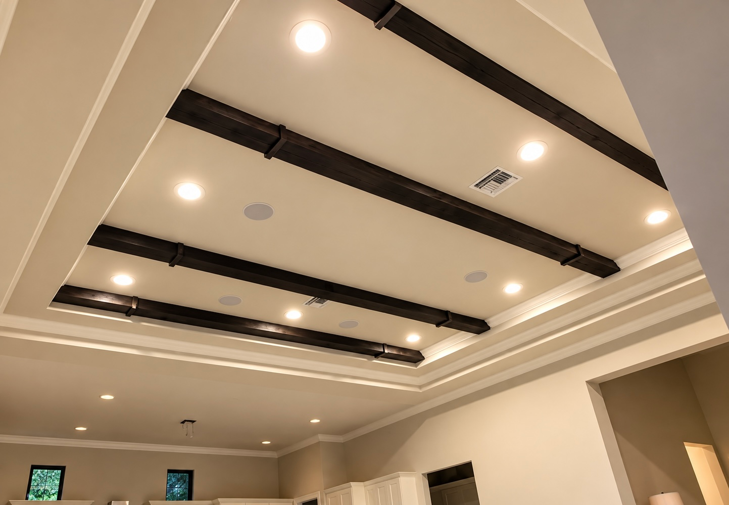Ceiling with recessed lights and dark beams in a modern room