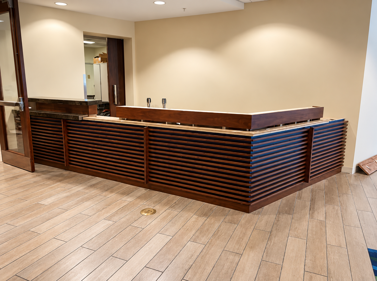 Empty hotel lobby reception desk with wood slats and beige walls