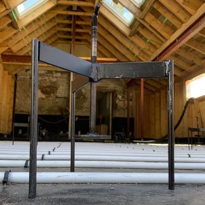 A screed tripod, used to ensure that your freshly laid screed floor is perfectly level.