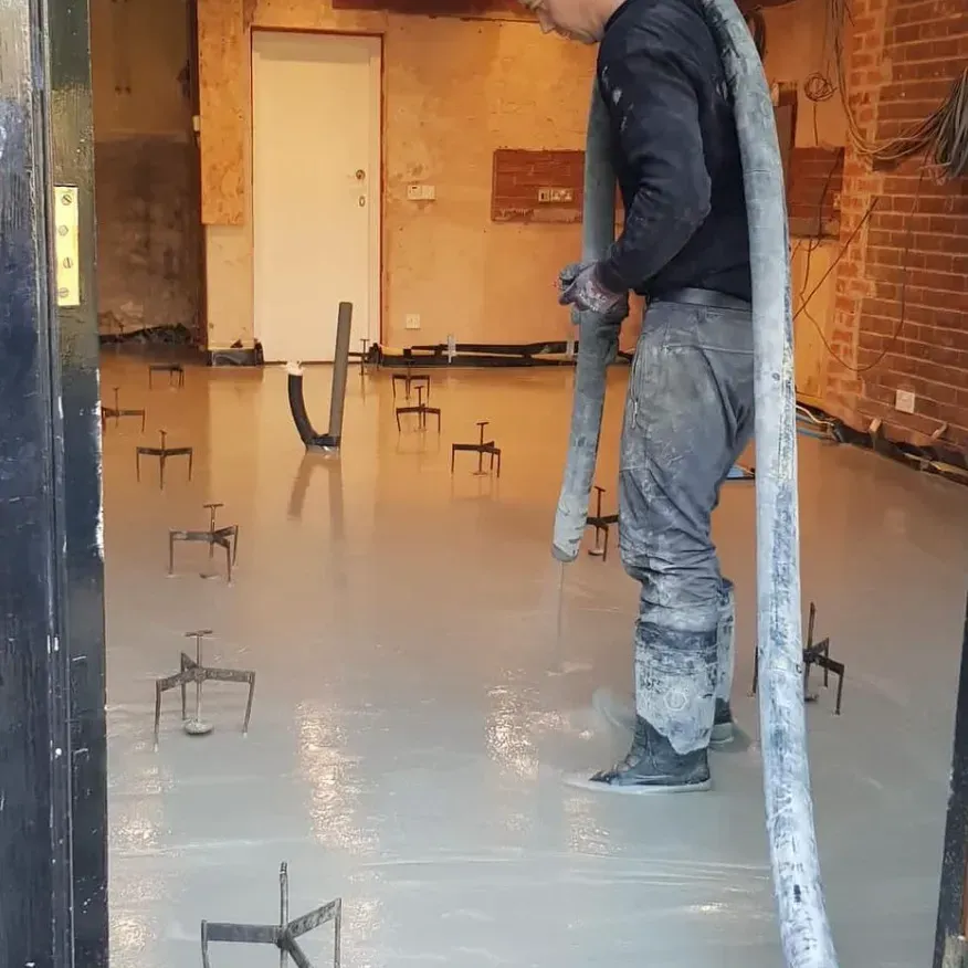 Pumping liquid screed into a room with screedpods to ensure a perfectly level floor.
