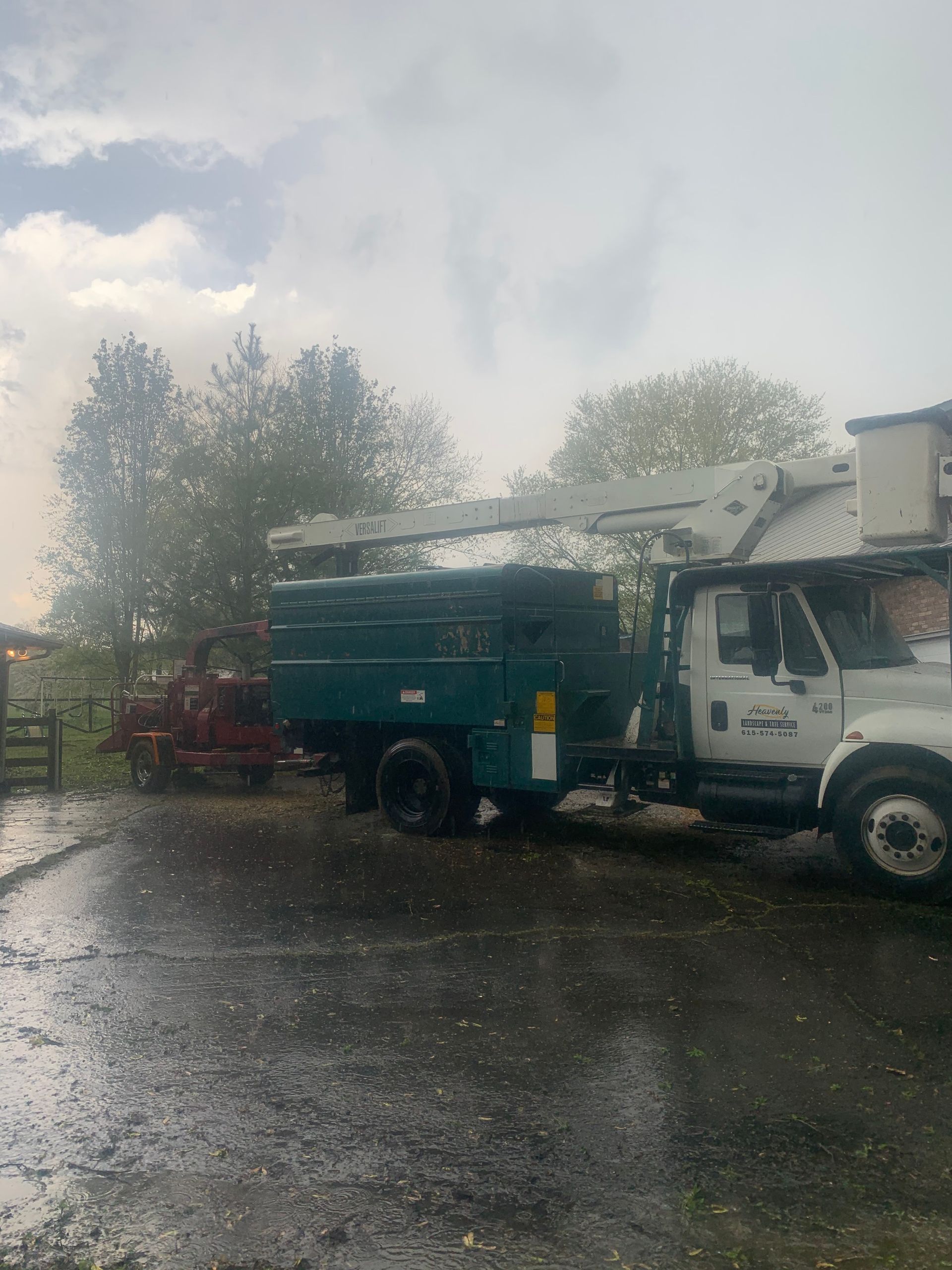 A truck with a crane on top of it is parked in a parking lot.