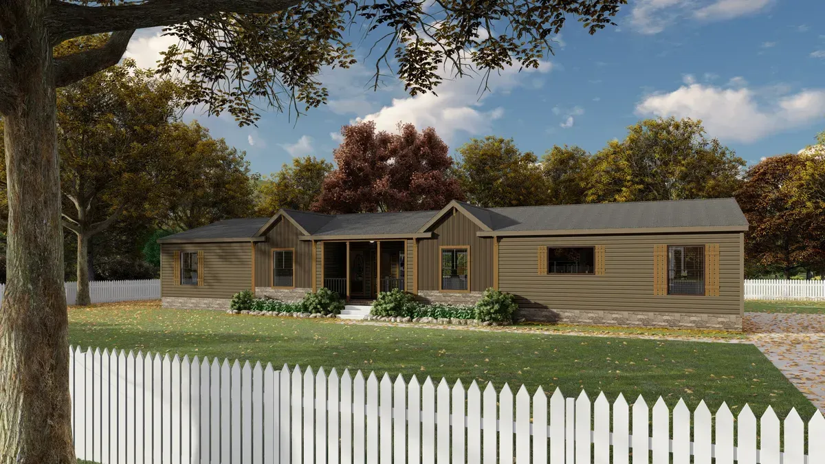 A log cabin-style house behind a white picket fence on a grassy lot, framed by trees under a blue sky.