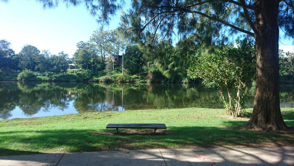 A Picnic Table Is Sitting Next to A Lake in A Park — AAA Equipment Pty Ltd In Kempsey, NSW