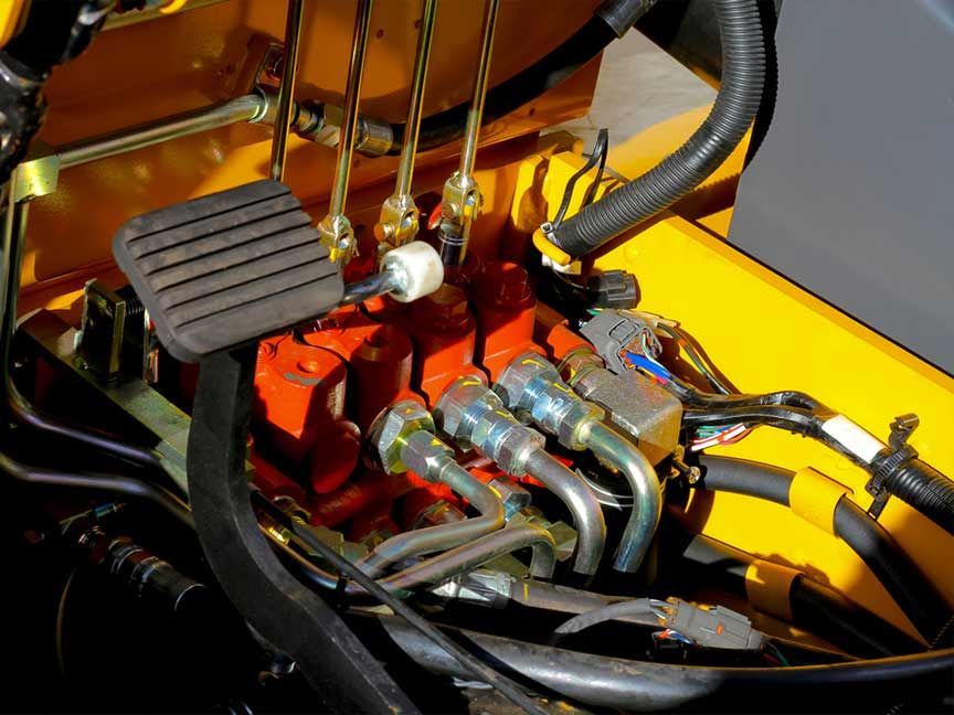 A Close up Of a Hydraulic System on A Yellow Vehicle — AAA Equipment Pty Ltd In Taree, NSW