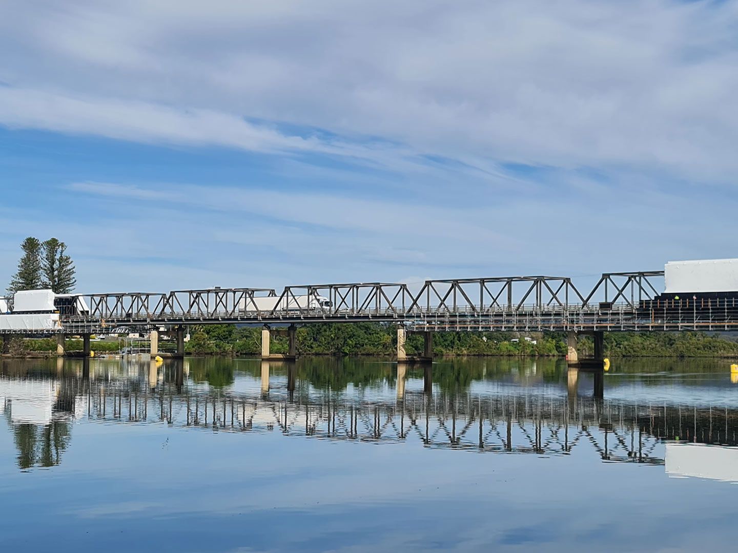 A Train Is Going Over a Bridge Over a Body of Water — AAA Equipment Pty Ltd In Taree, NSW