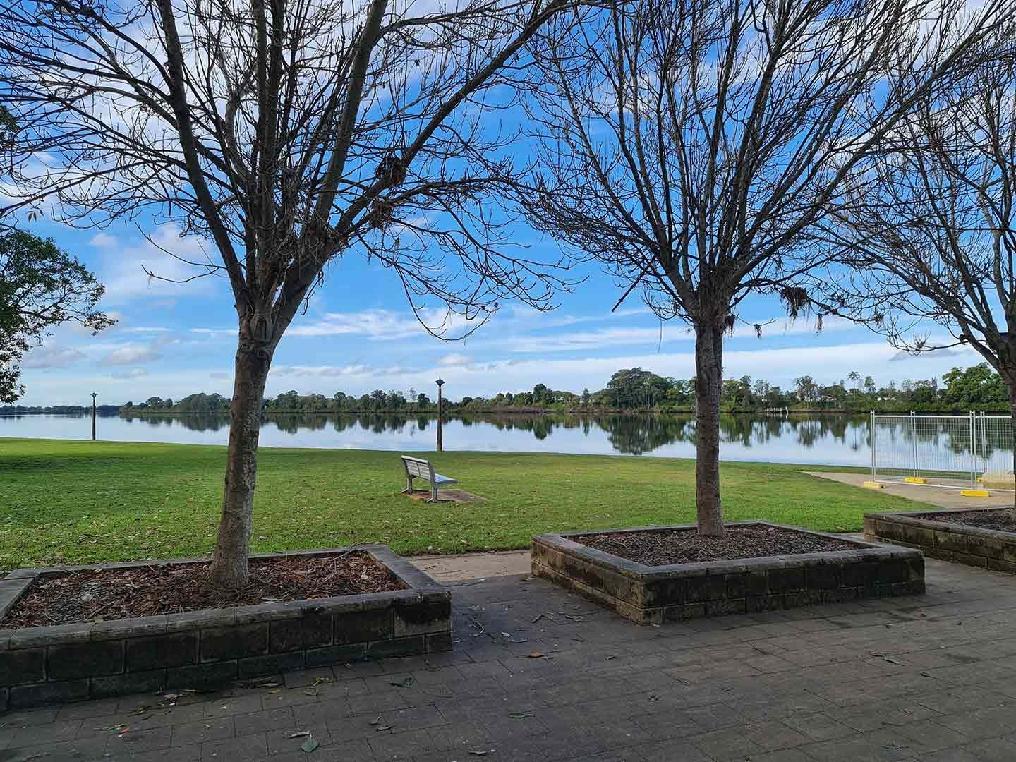A Park with Trees and A Lake in The Background — AAA Equipment Pty Ltd In Taree, NSW