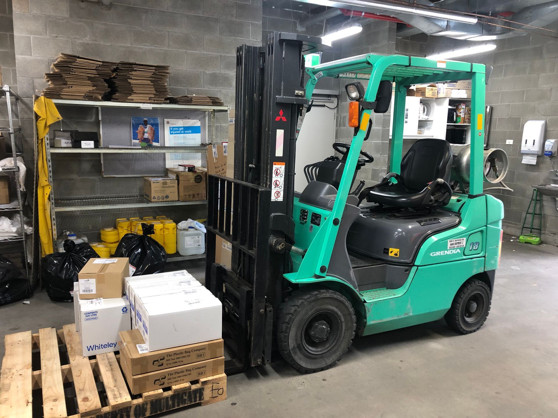 Forklift in A Warehouse Lifting a wooden pallet of boxes— AAA Equipment Pty Ltd In Redbank, NSW