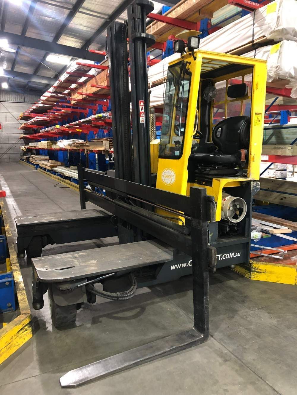 A Yellow Forklift Is Parked in A Warehouse — AAA Equipment Pty Ltd In Redbank, NSW