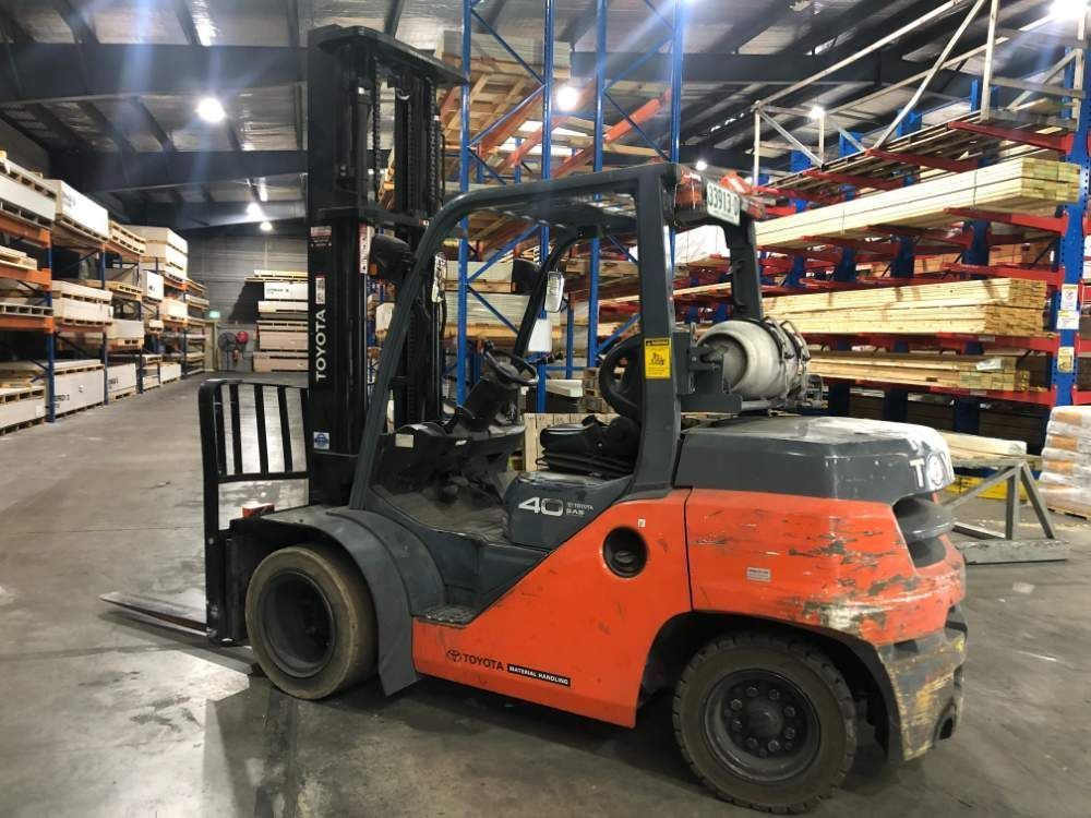 A Forklift Is Parked in A Large Warehouse — AAA Equipment Pty Ltd In Kempsey, NSW