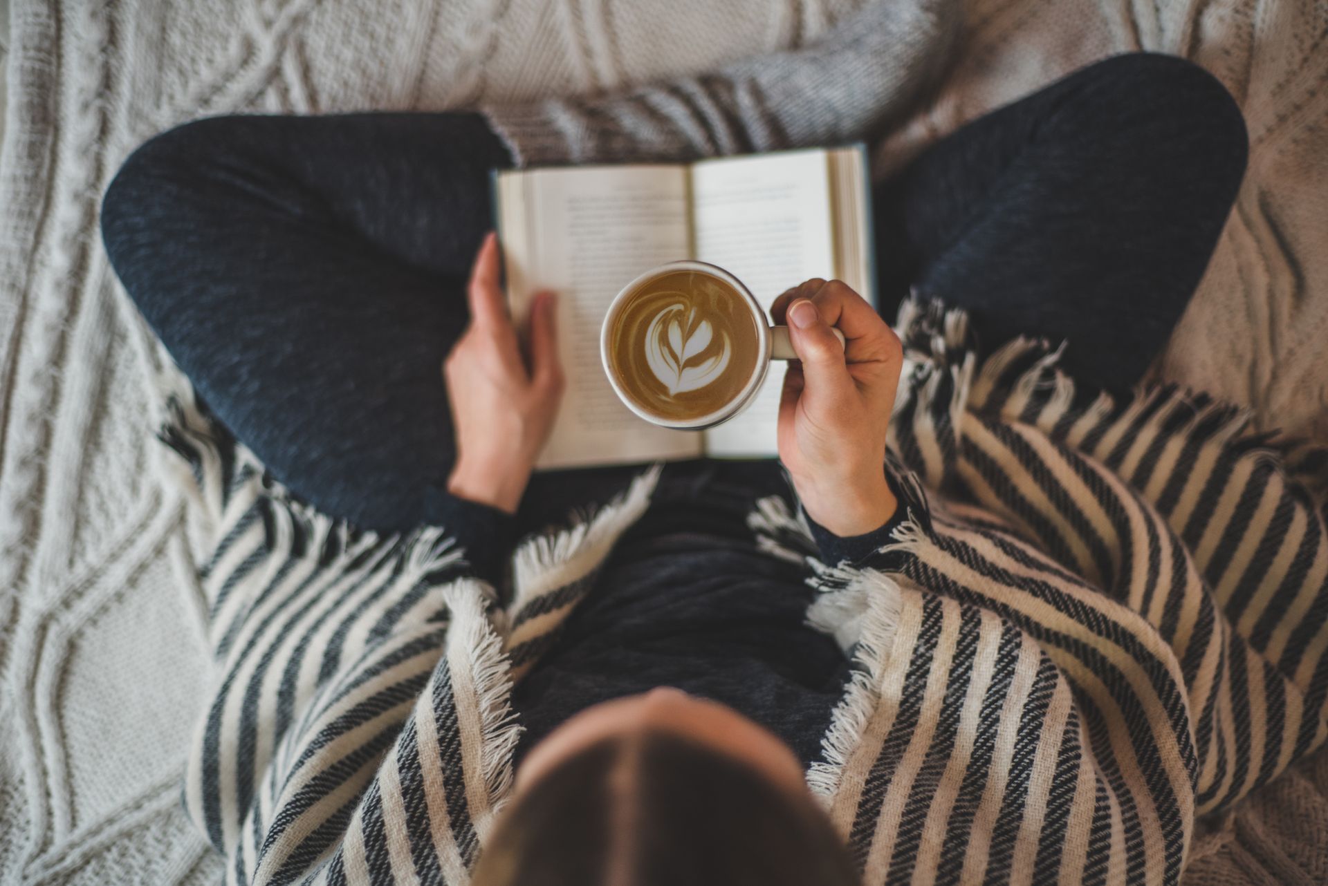 girl reading with book and latte