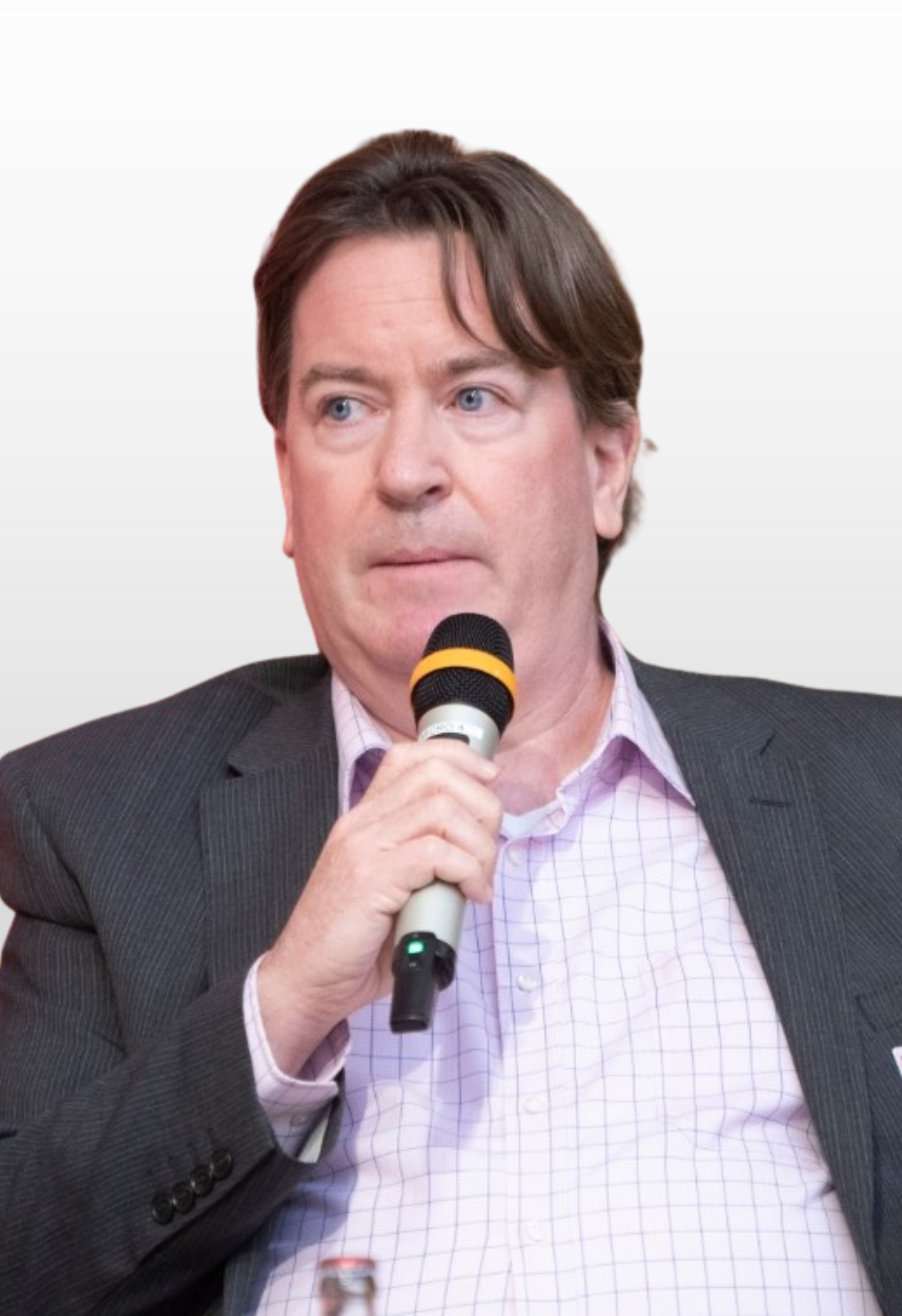 A man in a suit is holding a microphone in his hand