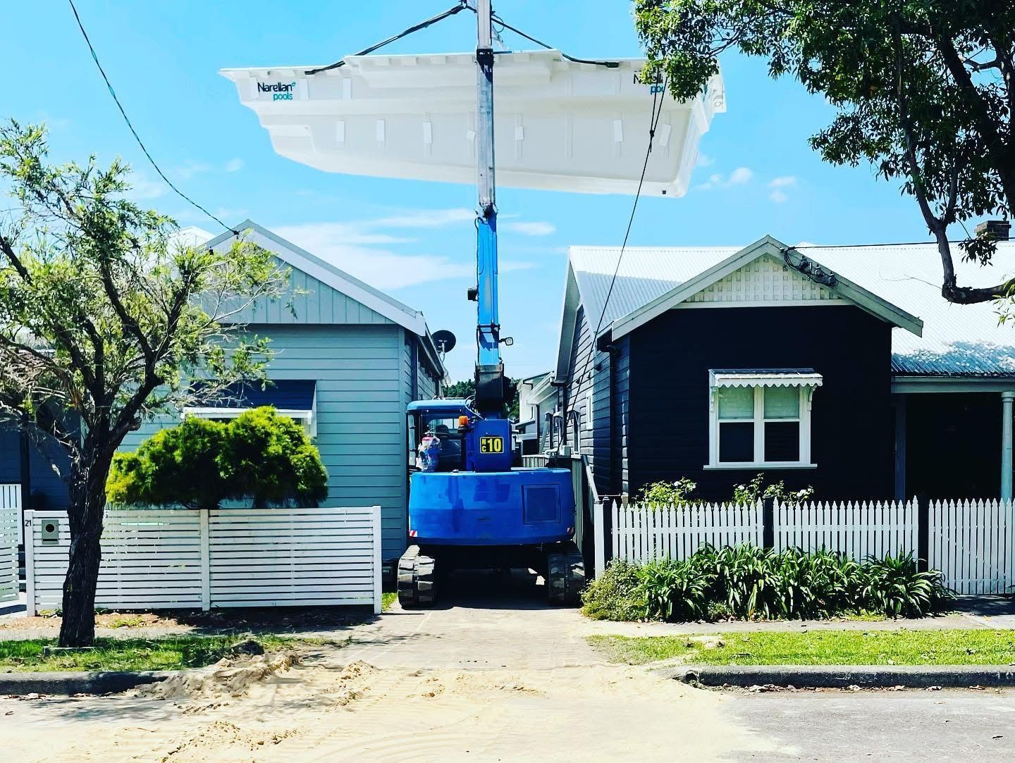 A Blue Crane is Lifting a Roof Over a House — Newcastle Cranes In Cardiff, NSW