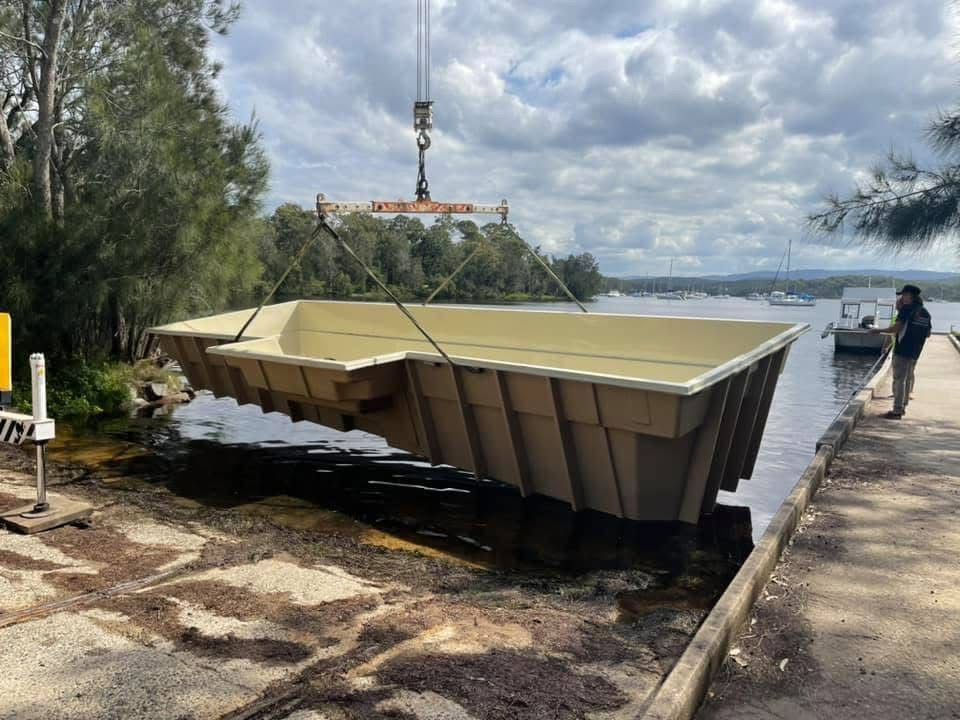 A Large Swimming Pool is Being Lifted Into the Water by a Crane — Newcastle Cranes In Cardiff, NSW