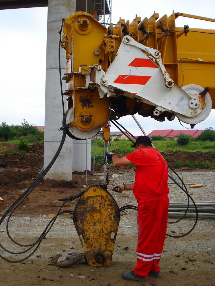A Man In Red Pants Is Working On A Yellow Crane — Newcastle Cranes In Cardiff, NSW
