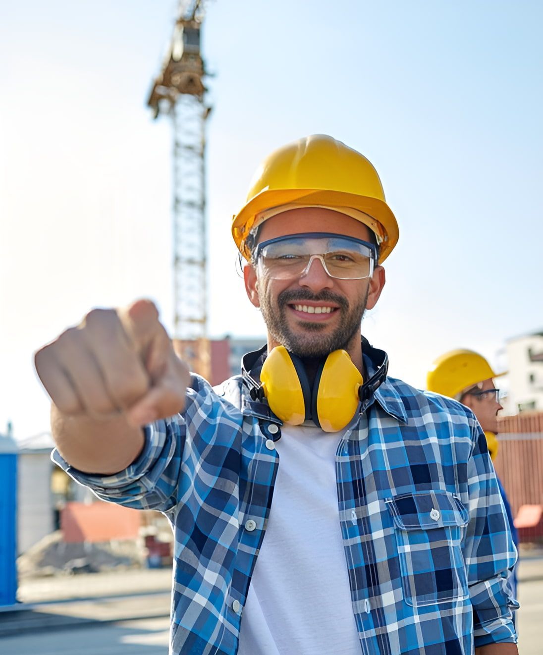 A Man Wearing A Hard Hat And Ear Muffs Is Pointing At The Camera — Newcastle Cranes In Cardiff, NSW