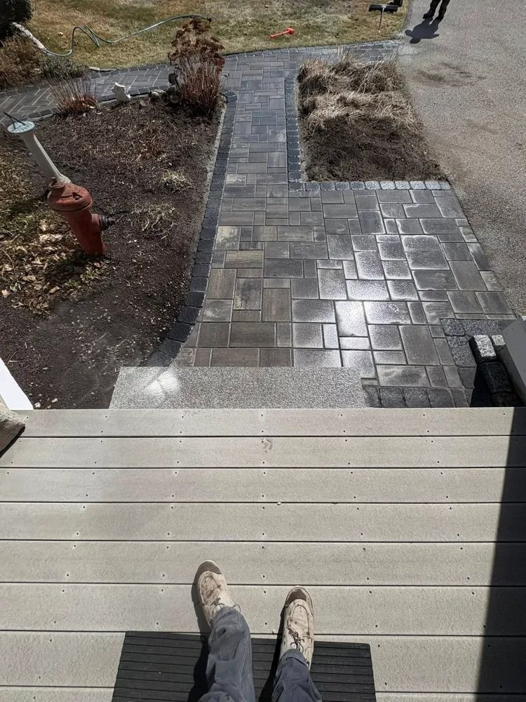 Person looking down at new brick walkway and steps.