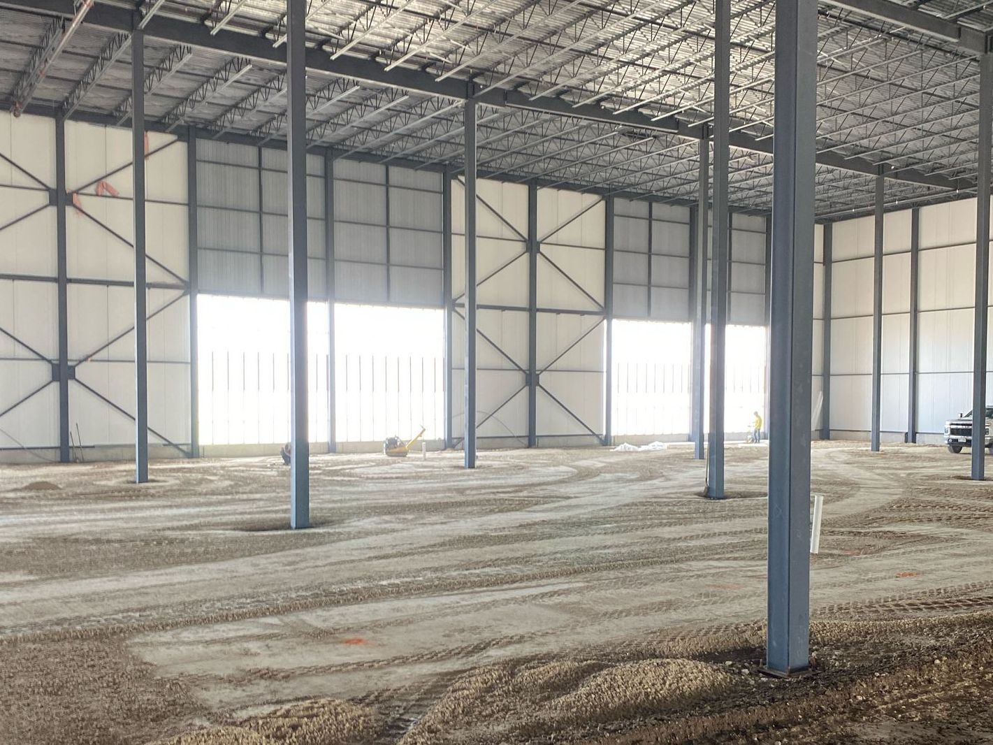A large empty warehouse with a lot of windows