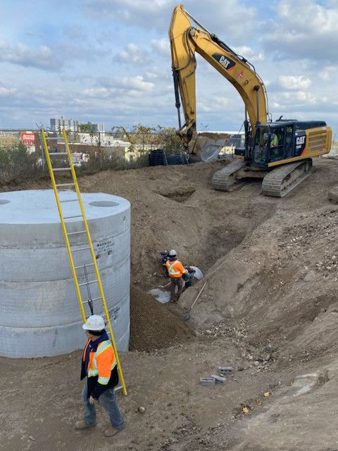 A construction site with a cat excavator in the background