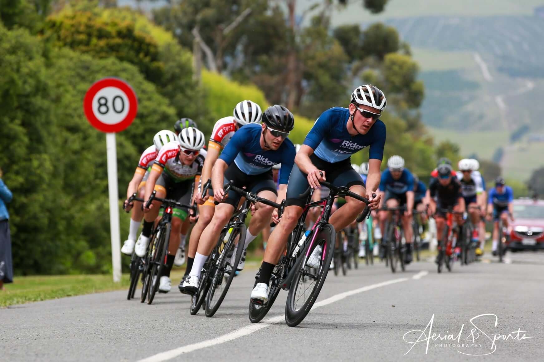 A group of people are riding bicycles down a road.
