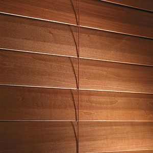 A close up of a wooden blind on a window.