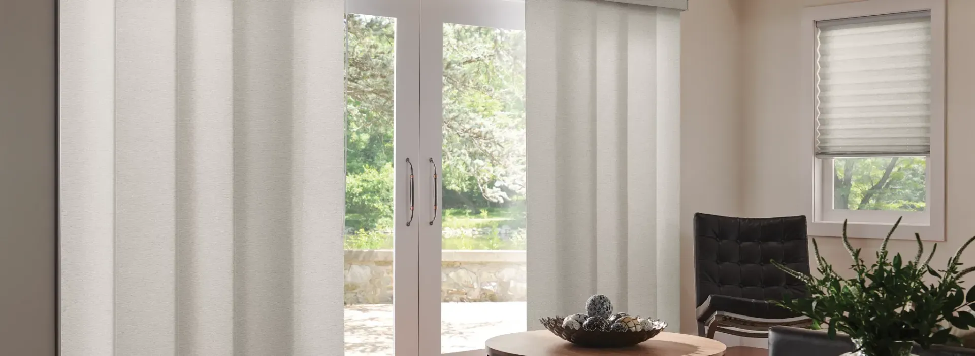 A living room with sliding glass doors and white vertical blinds.