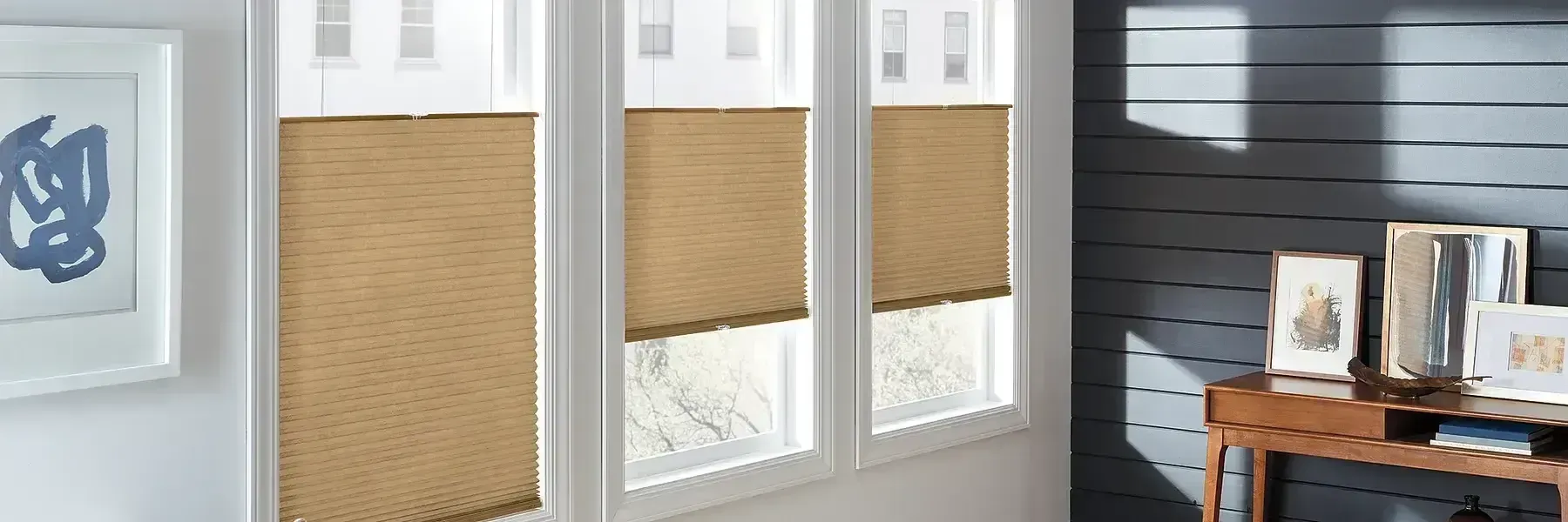 A room with a table and a window with blinds on it.