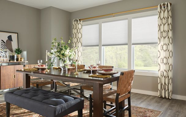 A dining room with a table and chairs and a bench.