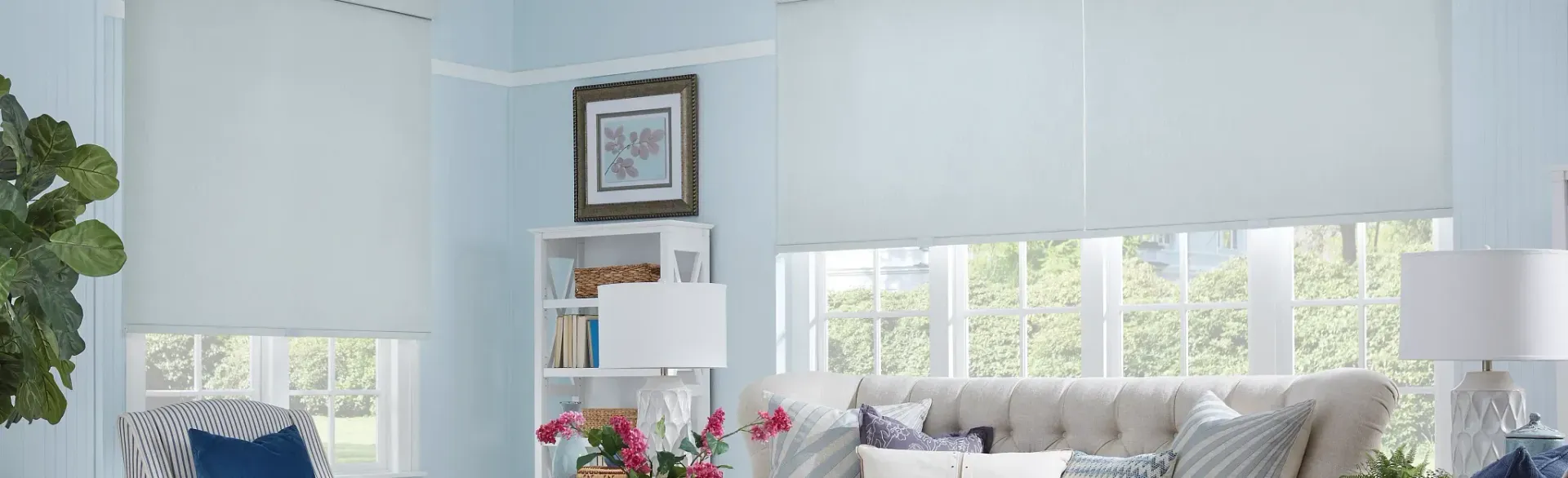 A living room with a couch , chairs , and a bookshelf.