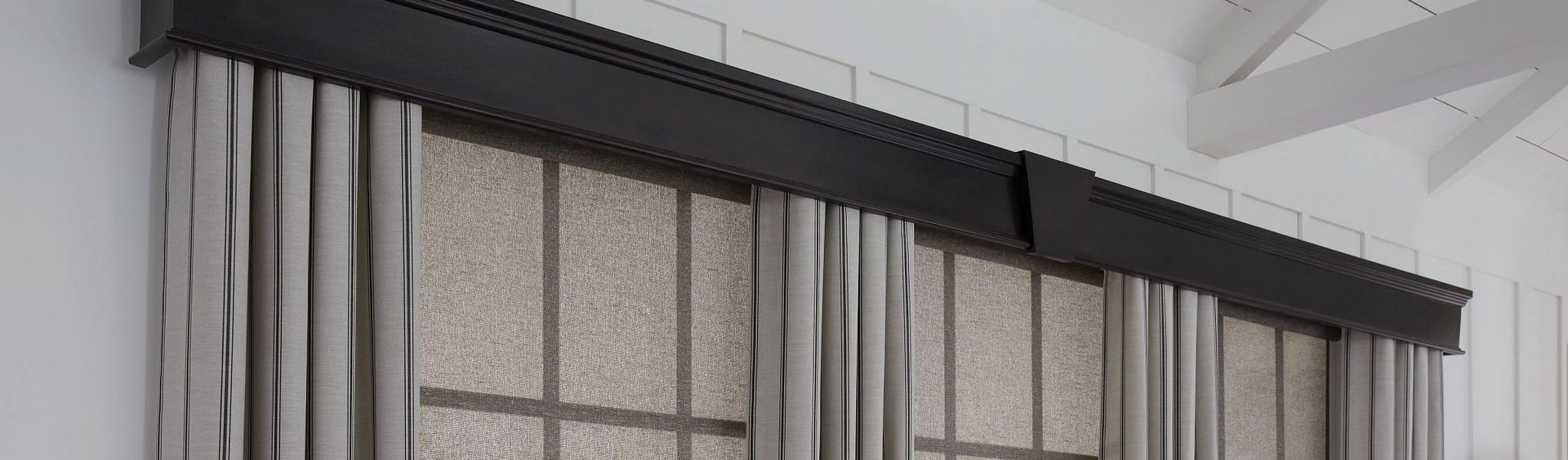 A close up of a window with curtains on it.