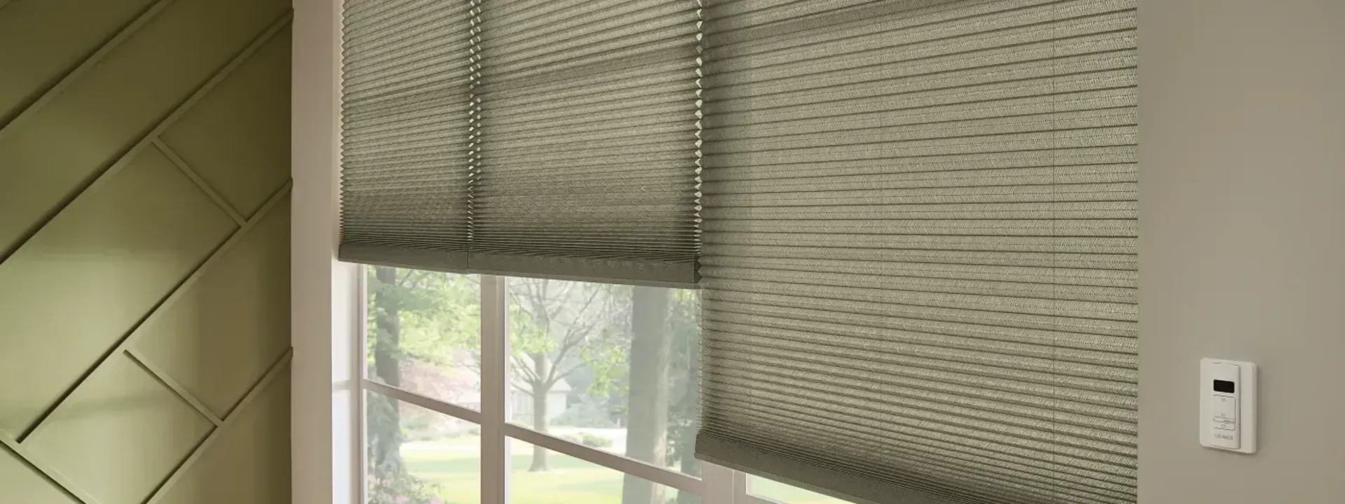 A window with roman shades on it in a room.