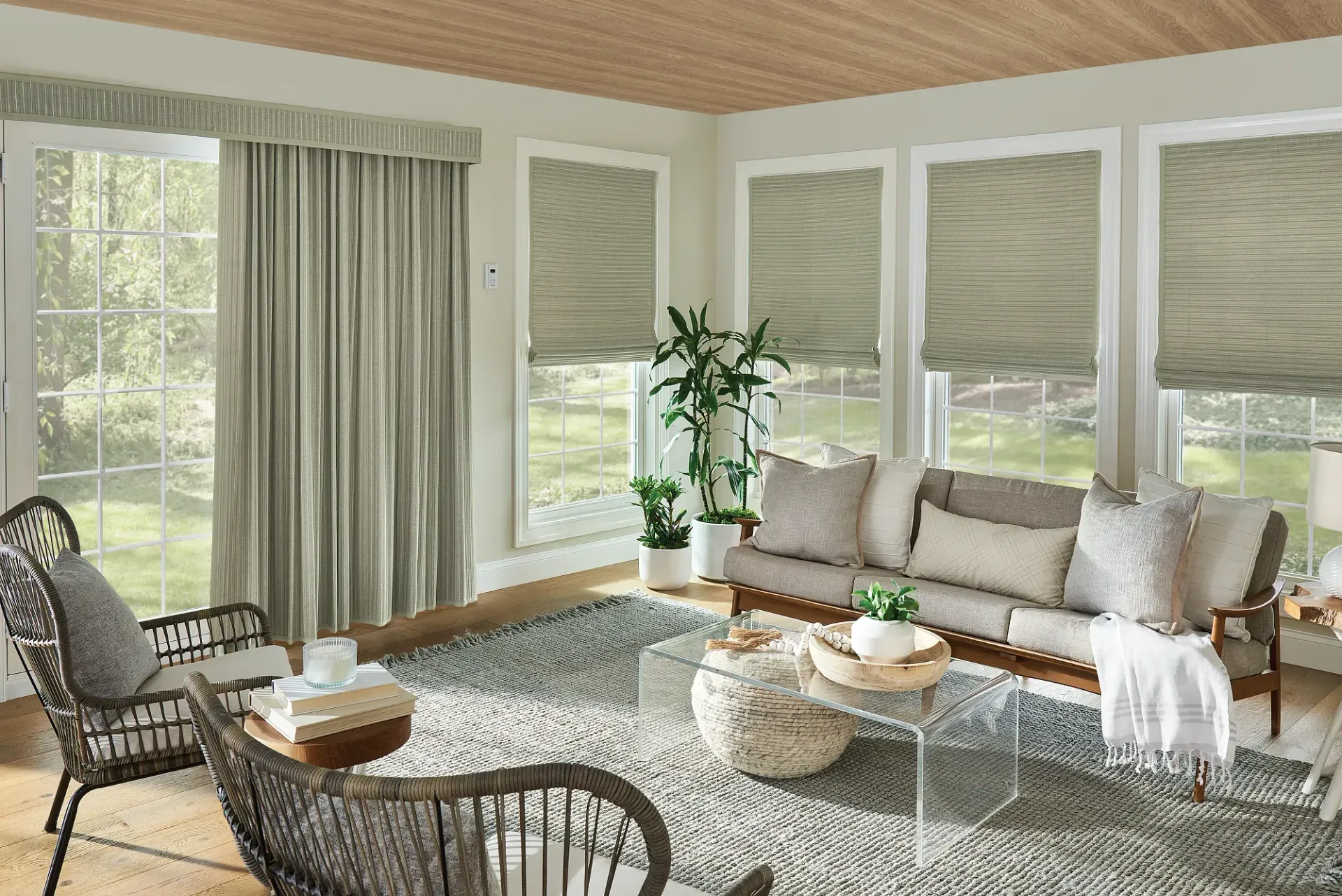 A living room with a couch , chair , table , and curtains.