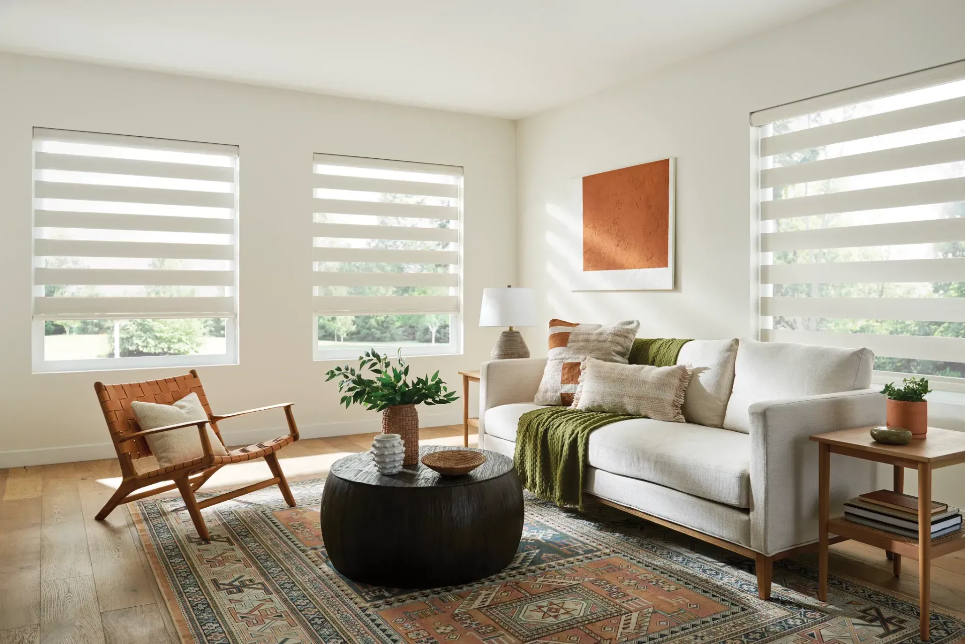 A living room with a couch , chairs , and a coffee table.