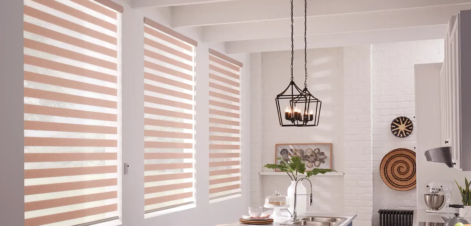 A kitchen with striped blinds and a chandelier hanging from the ceiling.