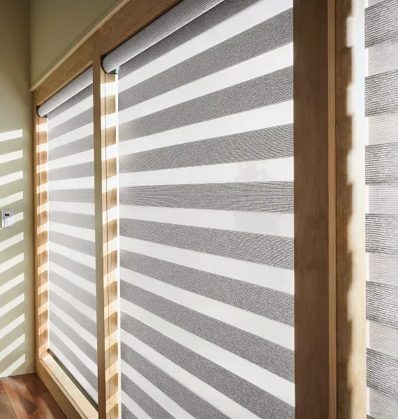 A window with gray and white striped blinds on it