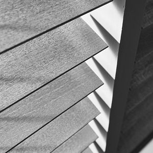A black and white photo of a wooden blind.