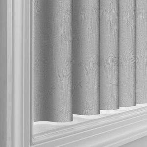 A close up of a gray vertical blind on a window.