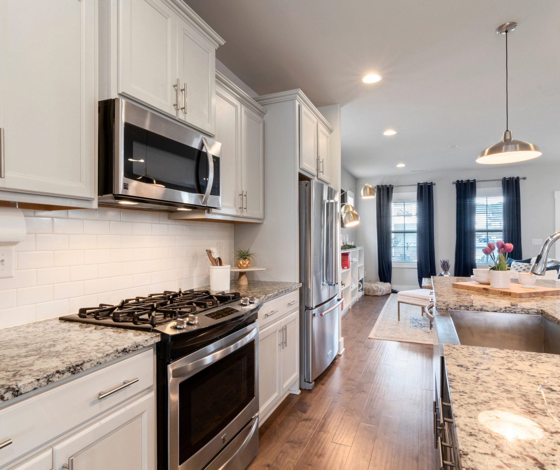A kitchen with white cabinets and stainless steel appliances
