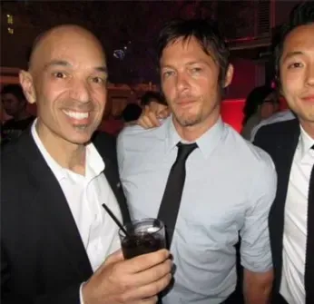 Three men in suits and ties pose for a picture