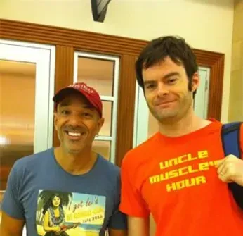 A man wearing an orange shirt that says uncle muscle hour