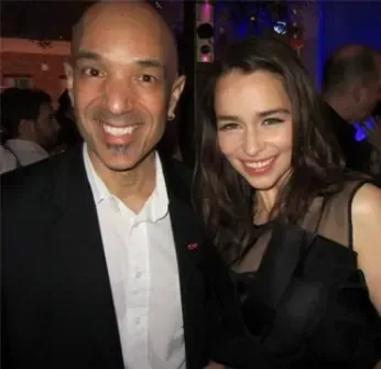 A man and a woman are posing for a picture and smiling